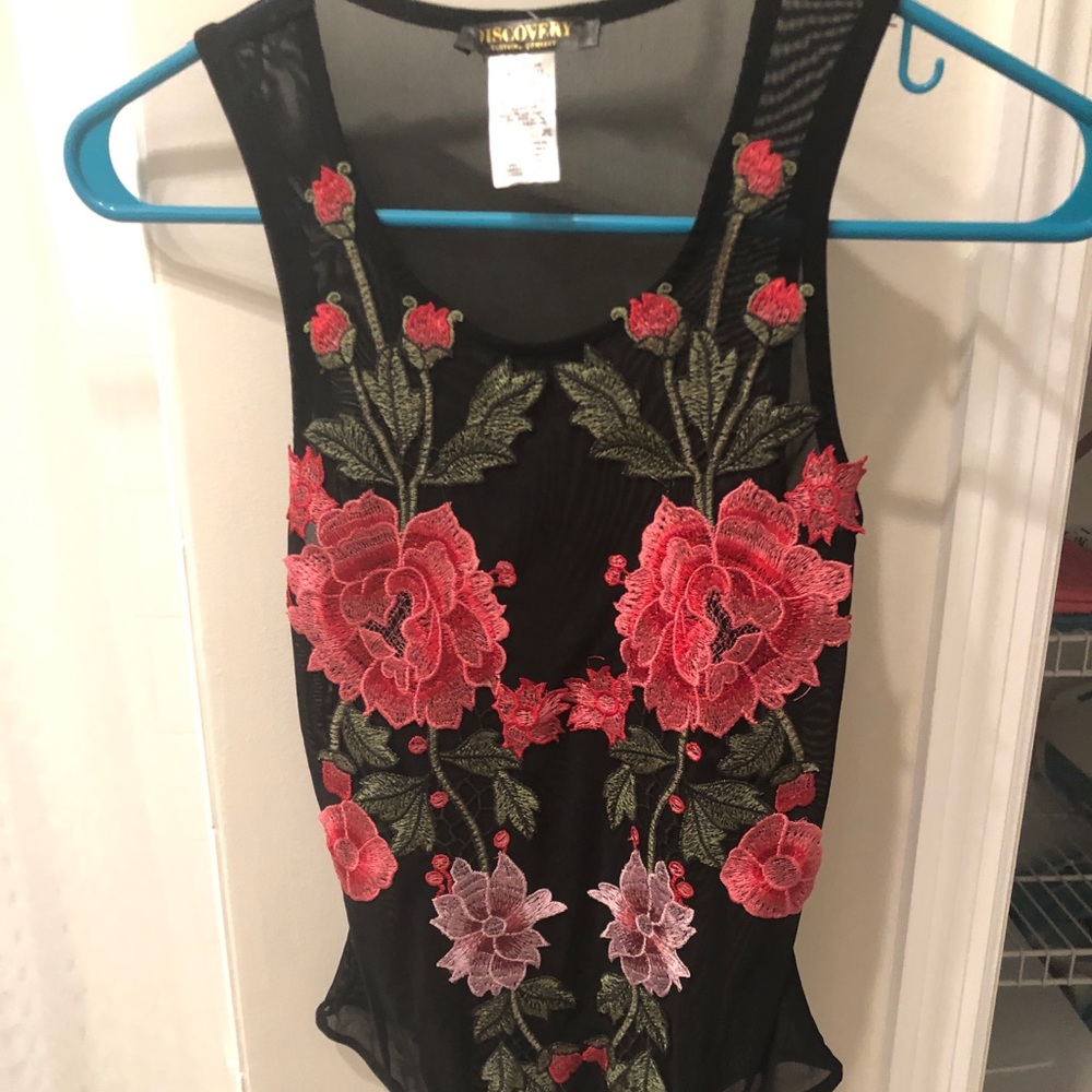 Mesh bodysuit with flowers on it